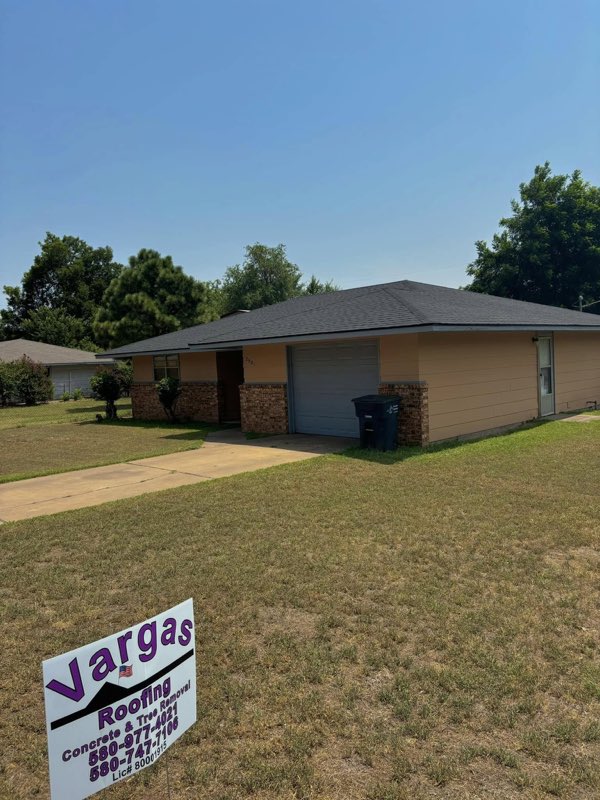 Completed roof with the Vargas Roofing yard sign